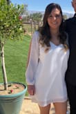 I purchased this dress for my courthouse wedding, and it could not have been more perfect. It is comfortable, simple, elegant, and polished. Although it is a shift dress, it doesn't make you feel like you are swimming in fabric. I was between a medium and large, but went with the large because of my chest. If you are between sizes, your chest size could be the deciding factor. Overall a beautiful dress!! - Kayli P.