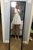 I plan on wearing this dress to my graduation because it is conservative but still has a party in the back. It fits awesome and there is no need to wear a bra with it! I ordered a small and it is a little short but overall it fits very nicely! - Cecilia V.