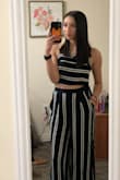 I love this jumpsuit!! I had to get the pants hemmed of course because I'm short but that's not a big deal to me. Other than the pants being too long it fit perfectly! I've gotten so many compliments and it's so comfy and the material is light so you won't get hot - Olivia R.
