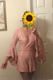 I love that this romper is not cheaply made. It is just right for this weekend's weather which is cloudy but not very cold. It is slightly loose in the back but wouldn't change size. I was thinking of ordering a XS since the model is wearing an xs but I was worried about the waistline being too tight on me so I ordered my usual size and it's just perfectly comfortable. - Raquel L.
