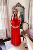 I ordered this to use as a formal maternity gown. At 6 months (27 wks) pregnant I weighed 145 lbs, and a large fit well. I did have the straps altered so it was not quite so low cut. Very satisfied with price and final look! I think I will be able to wear it again after baby is born. - Ginny S.