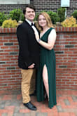 I am happy a ordered a large. Even though it was snug on the waist, it fit me perfectly everywhere else. The slit doesn't show too much, but it gives a hint of sexiness. My family and my boyfriend loved it. Also, it's totally worth every penny. The material is very thick and has three layers to it. - Chloe B.