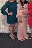 The dress material feels very smooth and not cheap. I was afraid it wouldn't fit either way, large or small, but it was perfect. Fits longer than the models which I was very pleased to find out because I could sit without it riding up too much. - Laurinda D.