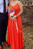 I wore this for my sister's wedding, and it was perfect! She did shades of orange and this was the darkest of other colors. The color is beautiful, and it fit perfectly. It was very long so I had to get it hemmed. It has adjustable straps which was very helpful and fit true to size. It has like 4 layers of fabric, but it's still super comfortable and light. - Lauren S.
