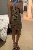 I love this dress - it does not stretch so it is very tight on my hips and fits perfect on my bust but I am pretty thin. I cannot wait to wear it on vacation to the night clubs in Cabo. - Kristen H.