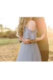 The skirt is very full and flowy! The length was somewhat excessive, but it was perfect for our golden hour couples shoot. The dusty blue was exactly what I was hoping for. It made my pale skin look creamy and warm instead of pasty! I was able to wear a bra with (criss/cross straps in the back), and it barely showed. Plan on giving it a really good steam for all those layers. - May D.