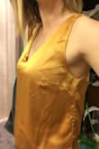 It is a little loose in the stomach area, which I like. So if you wanted form fitting, this isn't it. It fits true to size. It's a little short in the torso area, but that's okay I'll probably wear with high waisted pants. Very silky smooth. - LeeAnn B.