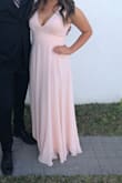 Fit perfect. The V-neck is a little low and I had to wear a bra that dipped lower than regular ones. I also hemmed it two inches to make sure I didn't trip (my heels were only 2 inches). I got so many compliments! - Taylor F.
