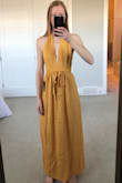 I love this dress, so cute and fun. The color is a lovely golden, same as the pics online. It is a perfect vacation dress. I am 5'10" and the only weakness is it is a touch short and for me will have to be worn with flats. The material is very light weight (great for heat) but also ever slightly transparent - careful what you wear underneath! It also wrinkles like crazy but is easy to iron. - Anna A.