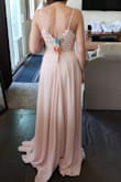 The back of this dress is gorgeous, but it runs large and long. It's a lot more of a soft pink than the picture online! - Bailey C.