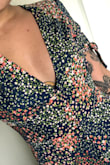 This dress fits so perfectly and doesn't cut me off at a weird length since I'm short and always struggle with midi lengths. It hugs my waist perfectly and the pattern is so pretty! - Cassidie M.