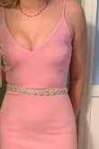 The dress is beautiful. I actually added a little rhinestone belt to it to dress it up a little. It is sewn on right along the upper seam. I also had a leg slit put in. - Carla A.