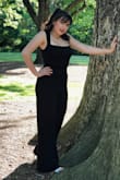I wore this jumpsuit to prom and loved it! I am an average height, and had to hem it up about 3 or 4 inches, so it was definitely a little long and fit for taller people. It fit really well on the top, but wish it was a size smaller on the bottom. Overall, it was super comfortable and I felt great in it! - Susan E.