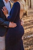 This dress is form - fitting, classy, and the back is absolutely stunning. Has ribbing in the back to keep the back/shoulders in place. So happy with this purchase. I'd but it in more colors if I had another wedding to wear it to! - Alyssa D.