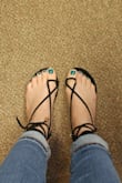These sandals are really comfy. The straps on the black sandals are a faux suede that's soft, so I don't foresee any blisters as I've had with other new sandals with straps between the toes. I had originally ordered size 7.5 which is what I always wear but had about extra half inch sticking out from the back. I returned them and ordered size 7. In my case, these run large or too long. The return process was painless. I work in an office setting but very casual construction business so i can dress these up or down. I also like that the straps feel snug and secure on my feet unlike other strappy sandals that feel like they're going to fly off your feet as you walk. This was my first purchase from Lulus and so far I am totally impressed. - Ileana C.