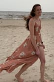 This dress is beautiful; the material is so soft and comfortable. I wore this dress to a beach wedding and I can't say enough about it. My one complaint was the size of the top, for a small it was a little large, but all in all I think it wore well.
On a windy beach it was a little difficult to keep the front from flying open because it is a true wrap dress, but if I had to go back and pick a dress again for this wedding I would pick the same one.
Last thing for you tall ladies out there, this is a small and it was almost too long in the back! So worry more about the actual dress size than the length. - Elizabeth B.