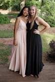 My best friend and I ended up wearing the same dress, she got the pink in XS and I got the black. The dress was very flattering on me and I loved the way it flowed and made me feel like a princess. It is a bit heavy (and long, we both had to get it tailored but we're short so that's expected), and I also had to get it pinned up in front, my mom thought it was too low/ revealing. I guess it depends on your bra size because it didn't effect my friend at all, and besides that I love the dress and I'm very happy I got it! - Annie L.