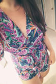 I fell in love with this romper as soon as I saw it. I usually wear a medium to large and I wanted a looser fit so I ordered the large. It fits beautifully on top but is very short on my torso and shows a little too much booty. I'm not going to return it because I love the colors and I'll probably use it as a beach cover-up. But I definitely wouldn't be able to wear it to an event because of how short it is. - Melissa M.