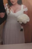 I loved this dress and HAD to make it work for my wedding the minute I saw the photo. The bust runs super small or maybe it's just not designed for large busted women? Had to add a modesty panel and it was still quite revealing, but I loved it anyway. Just be prepared for a lot of cleavage from all directions if you have a bigger bust! - Kelsey P.