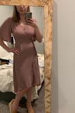 I got this dress to wear to a nice wedding. It looked great on once I figured out how to assemble a wrap dress but it was a little awkward in cleavage region. Everything else about the dress I loved, it was comfy and cute but I tried multiple bras and tied the strings as tight as I could but I still was self conscious the entire night of my bra accidentally showing since it would periodically need to be adjusted for just that problem. - Madeleine P.