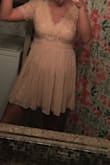 I was a little nervous to order because obviously I couldn't try it on before I bought it, but I am absolutely OBSESSED with this dress! It really does look the the picture, the lace is firm but not like hard? So you can lift your arms without discomfort and move around without feeling stiff. I ordered it for a wedding and I can't wait to wear it!! My bathroom has bad lighting haha the dress is actually a plush pink but the picture looks peachy sorry. - Renee G.
