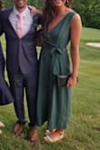 I never really thought that rompers would work for me, but I took a chance and ordered this one for a wedding, and it is the most flattering outfit I own now. I'm obsessed. It is a flowy material, so it's a bit more dressy in my opinion and really easy to dress up. I ordered a large initially because I thought it would be too short for my longer torso, but it ended up being way too big. I exchanged for a medium and it fit perfectly. The sides were still a little loose and I could have maybe even tried a small, but I was comfortable in the medium so I just stuck with it. I wore a regular bra with it, and didn't have any issues with the top falling off. I think if that happens a you just might need a smaller size. Get this romper, you will not regret it! - Bella K.