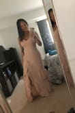 It fits perfectly where it counts, which is the bust but I will say if you're petite like myself, you have to take it up quite a bit or wear heels. - Minh N.