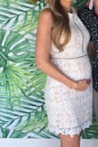 I have found maternity clothes are not the cutest, but going up a size in lulus has worked well for me! I usually am about 138 at 5'9" pre-pregnancy and usually wear a small or medium. I ordered a large as I am 28 weeks pregnant and now 154 pounds. It was slightly loose on the top but fit well around the bump. It was conservative enough to be around family but still very cute. I love this dress and hope I can wear it again. If not I will get it taken in to wear post pregnancy too. - Susan C.