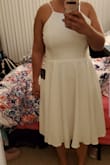 The dress is cute and great quality, but it was too big on me. I got a large and it was too long (went over my knees, not midi). It made me look a little stubby. The top was a little big too. It's nothing too bad, but I feel like it not fitting well made it a little less flattering. - Mary L.