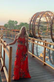Gorgeous dress. I got so many compliments wearing it to a fancy dinner in Cabo. I say, don't worry about the sizing with this one, both top and bottom are easily adjusted to tie however tight or loose you'd like it. The fabric is very nice and in the wind it flows beautifully. - Madison N.