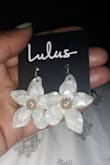 I have not worn these yet, but these earrings are nice and light weight, which is a plus for me because I don't like heavy earrings. The earrings are made of out what feels like acrylic, possibly plastic, yet still very high quality. The only thing I'm noticing is the earrings online are pictured different from the photo. In person these are more like an off white with flecks of silver, that is not what I expected. I thought these would be a solid white color like shown, but nonetheless these are still cute and worth the price. - Kierra W.