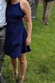 This dress is so cute and the best part is you don't have to wear a bra! I wore it to an outdoor wedding and it got a little chilly, but no one would know! I ordered a small and it fit fine, but I could have gone with an XS and it would have been fine, too. I'm usually right in the middle of a S/XS. I also spilled food on it and I swear it just disappeared off the dress. There is not a trace of the spill. It's amazing. It was windy in the picture, but the dress flares out nicely. - Libby S.