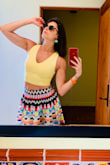 I absolutely love this top. The material is super soft. It's brighter than the model photo (I think) and I love that. It's cute to pair with skirts, shorts, and pants, I prefer bright colors but I've also worn it with dark jeans too Fits very comfortably. - Mariel L.