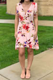 This dress is very pretty and made of a nice thick material that still flows. It is a little shorter in the front than the back. It did feel a little big on me, so it does run a little big. Overall super cute! - Kaitlyn S.