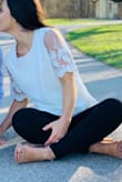 I really like this top and wore it for engagement photos. Super cute. My only issue with it was that you can see the solid white fabric where it is sewn together with the mesh material on the sleeves. You have to fold that part down which is difficult or else you can see it through the sleeves. Overall super cute. - Kaitlyn S.