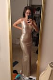 I'm going to wear this for my wedding reception. I previously got my ceremony dress in an XS, but the material had no stretch and it is a bit tight on my hips, so I got this one in a small and it's fits pretty well. With the stretch I could probably fit in an extra small too, but I couldn't go a size up because I'm not busty enough. My waist is 28.5 when relaxed and 26 when I flex my abs. The length is perfect when I wear 3 inch heels. As you can see in my photos it's not really silver, but I think it looks close enough in real life to the photo. I'm standing in a very warm light in my picture. - Nora F.