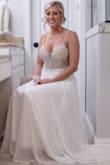 I fell in love with this dress before I was even engaged but I knew when the day would come, I would definitely buy this dress. Buying online can be scary but this dress is by far prettier than most dresses in a bridal boutique. It fit me perfect, I did have the bottom hemmed so I wasn't stepping on the front of it and I had a bustle added as well. The only thing I did not like was where the dress has the placement for handing it. It's on the material under your armpit so when you try to cut it off or I had it moved so you can still see an area of it. I would recommend placing it lower in the dress where it is not visible. - Brittney F.