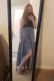 After reading the reviews I went with a Large and I should have sized up. I'm at the very edge of it being too tight but I'm trying to lose weight so I'm keeping it. It's a false wrap (side zipper) with two sewn in ties you can tie in the front. It's a super cute skirt that is lightweight but you can't see through! When the wind picks up, just keep ahold of your skirt or you will end up with as much leg showing as the model (or in my case I flashed my husband, oops). - McKenna I.