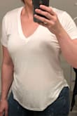 Based on the other reviews and measurements I decided to get a small, rather than my usual medium. I'm glad I did because I love the way it fits. This shirt is meant to be looser so if you like yours slightly more fitted, as I do, size down. It's a tad see-through but if you wear a skin colored bra, it's not noticeable but you can see my shoulder tattoo through the shirt. - Courtney C.