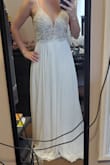 The dress was pretty. It's very long for someone my height. I also found it to be loose in the back. It looked nice but for the price I returned it to get something that fit better. - LAUREN K.