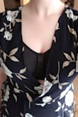 Compared to some other dresses from this site, this one runs a little smaller. It "fit" but didn't wrap around enough to cover the bust. 
It is cute though: hits right above/at the knees on the front and slightly touches ground the the back (probs need to be 5'8" to have it not touch the ground at all). It is flattering at the waist as well.

The flowers were this weird dusty blue-green color (not real or turquoise but parts blueish, parts greenish). It could be a little matronly for some tastes. If you order it in a size up, I'd probably consider a brighter color.

Photos show it in (overcast) natural light and fluorescent light. - Lauren A.