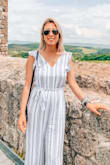 I am IN LOVE with this jumpsuit! I wore it all around Italy and it was perfect! It is a great length, (not too long, not too short,) and the fabric is wonderful! (Italy is so hot this time of year I didn't want to be too warm.) It runs true to size which is great for online shopping. This jumpsuit is a must have this summer; highly recommend! :) - Emily R.