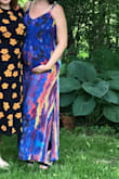 I sized up from my regular small to a medium (usually weigh around 140 when not pregnant), and at 8 months pregnant it worked! The colors of this dress were just as vibrant in person and I received many compliments! Very happy with my purchase. - Kate M.