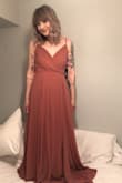 This dress is so pretty. It's fully lined and the straps are adjustable, so it doesn't reveal too much. It is LONG though. I spent more than the dress cost just getting it hemmed. Worth it. :) - Alison F.