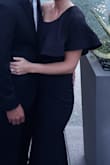 I ordered this dress as a bridesmaid dress. I tried XS and S and kept the XS. It was really long, I took 3 inches off the dress length and still wore 4 inch heels. The material was nice, it had a little stretch to it but very form fitting and felt textured. I was unable to wear panties as even the seamless ones still showed a line. I received many compliments. The reason I have 4 stars, the stitch work on the ruffle part was poorly done. - Katie B.