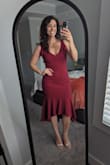 This dress is adorable on the model, but DAYUM, it looks even better on! Very forgiving material (great quality) and the color is a gorgeous deep wine. All the stitching and details (bows on the shoulders) lay perfectly. Great wedding guest dress or fancy date night. LOVE. - Danielle B.