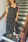 It hugs all the right spots. It's flattering for all body types especially a full figure mama like me. It helped me hide my belly after 5 babies with the middle ruching on the dress. - Daniela Z.