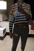 This sweater is super cute but it's more cropped than you would think. I read reviews saying to size up and so I got a small instead of my usual XS and I think I could have gone with a medium. I love it but the sleeves are a little short for me. - Mariah Q.