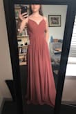 The first thing that I noticed unboxing this dress is how heavy it is. The material is nice and thick, and there are several layers to the skirt. As others have mentioned, the skirt is very twirly and flows nicely. Lovely color for pink skin tones. I bought it thinking I would wear it for engagement photos, and it was the 2nd choice dress. The top felt a little big on my, which could have been remedied with some well padded bra cups, but I ended up feeling a little too much like a bridesmaid for what I was looking for. - Kelly G.