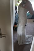 This is a really nice dress! It has some stretch, so if you want it to hug your curves more or are in between sizes, you could probably get away with sizing down. The fabric is heavy, but the way the dress is designed, it doesn't fall down. Straps are very thin and pretty pointless. Pleating in the front might be awkward on some people (depending on leg length or booty width?). If it hits you at mid-thigh it pulls a little and looks cheap, if it hits on the lower thigh, it's a nice mermaid look. Not too low cut in the front, but also not frumpy (might be large on smaller chested people). The lining is a nude color and it is very apparent through the lace overlay. It is kind of long on an average height person and might be hard to hem because of the beautiful lace (skims the floor when I wear platform wedges). The back is a little boring, but allows you to wear any bra you want (although it would be nice to have a lower V in the back for some interest.) Love the train detail at the bottom. Overall great dress, especially for the price. - Sarah D.